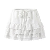 LIZAKOSHT - Sweet Women White Embroidery Hollow Out Hole Mini Skirt Lacing Up Bow Drawstring Waist Spliced Wave Lace Saia Cake Skirt Girl