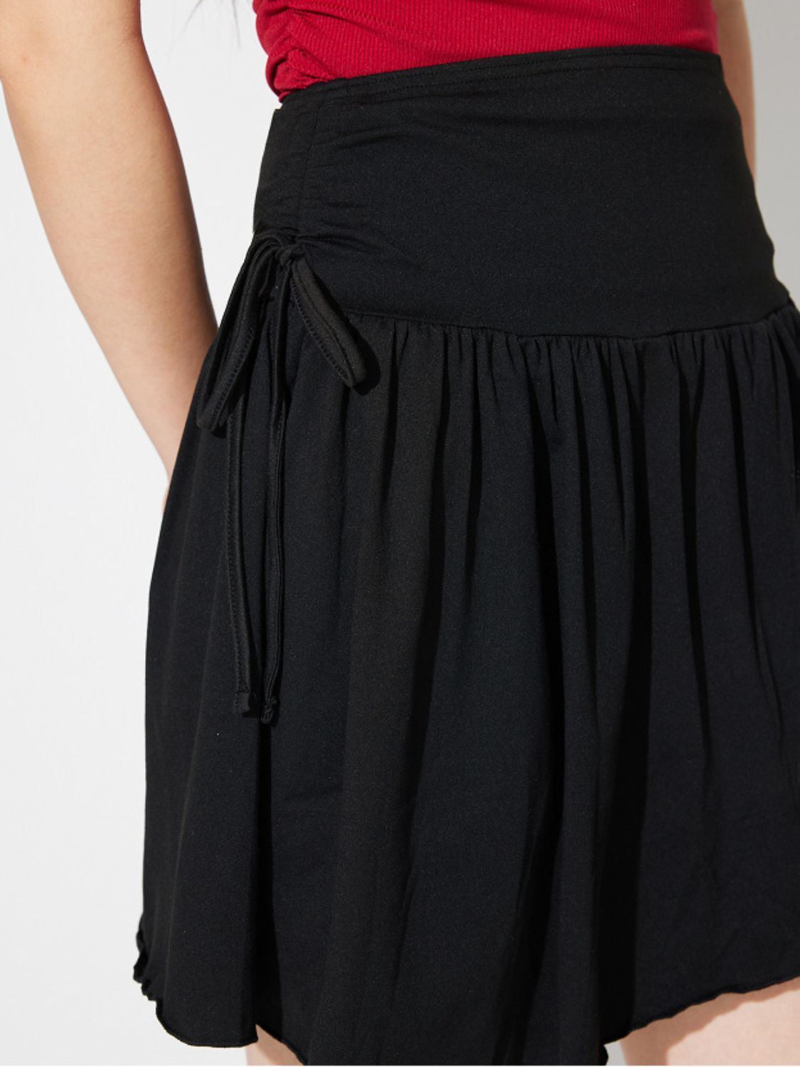 LIZAKOSHT  -  Side Tie Asymmetric Hem Mini Skirt