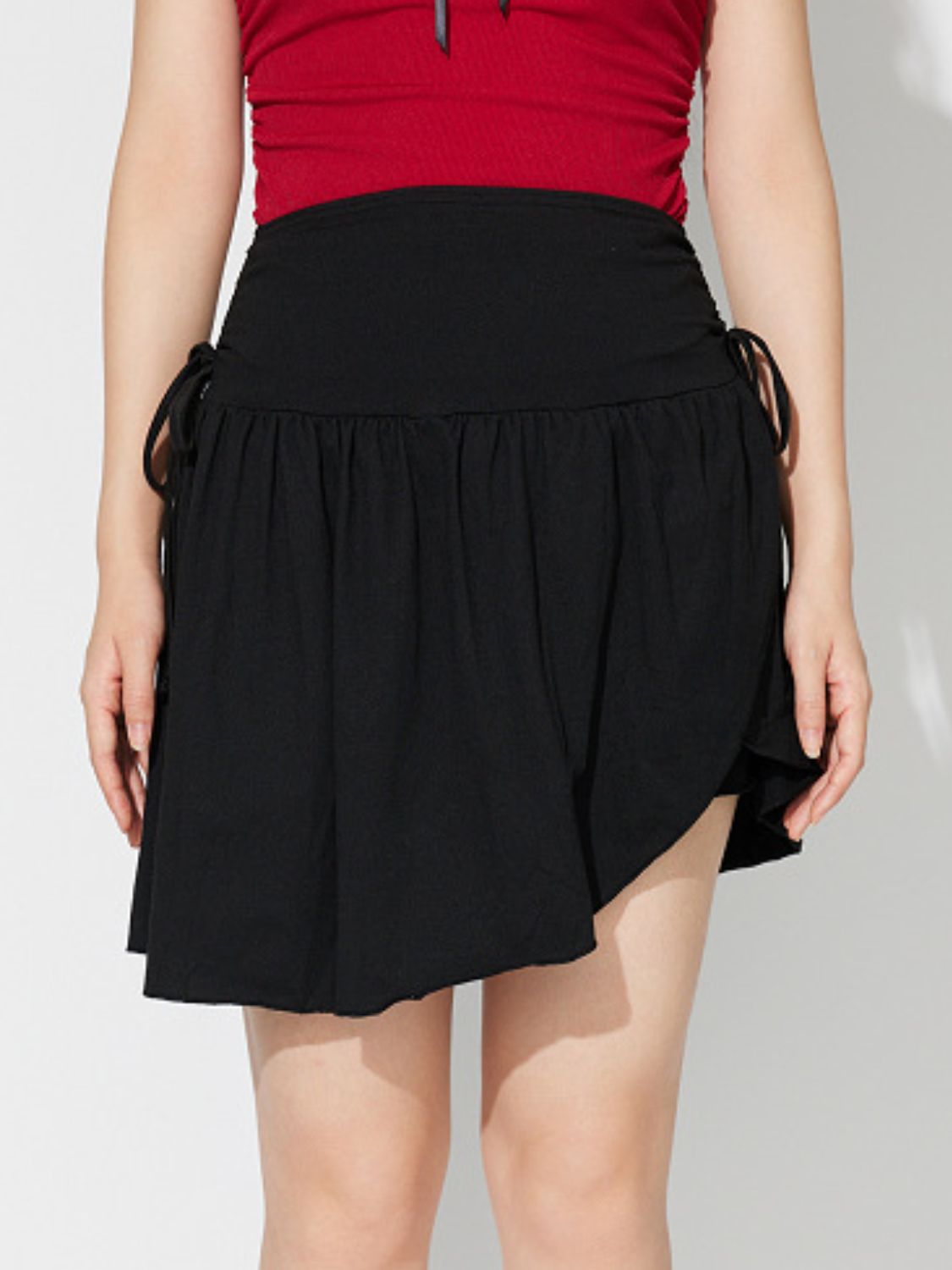 LIZAKOSHT  -  Side Tie Asymmetric Hem Mini Skirt